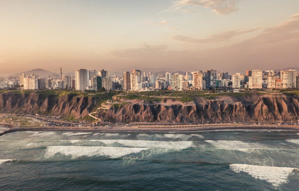Coastal cliffs and green parks along the Miraflores malecón in Lima at sunset