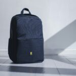 Black travel daypack on a light floor, ready for a Peru sightseeing day