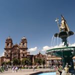 First day in Cusco: Plaza de Armas with turquoise fountain, golden Inca statue and church towers