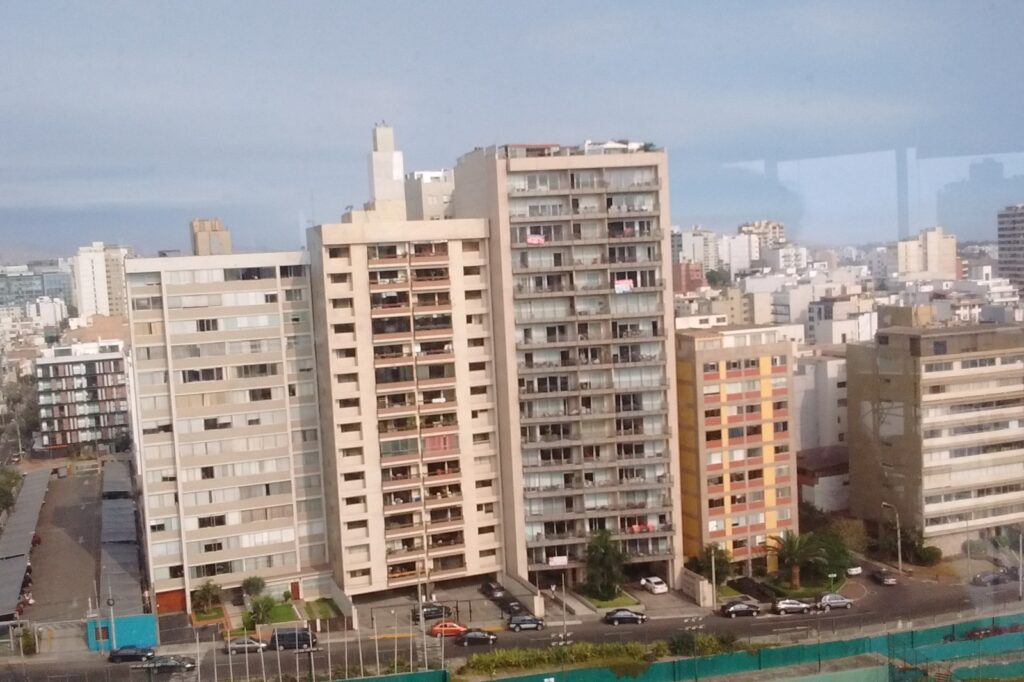 Coastal avenue and cliffs in Miraflores, Lima, with ocean view and city buildings